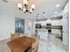 Eat-in kitchen featuring white cabinets, granite countertops, stainless steel appliances, and tile flooring at 345 Alcove Dr, Groveland, FL 34736