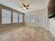Spacious living area with tile floors, ceiling fan and lots of natural light from the windows at 345 Alcove Dr, Groveland, FL 34736