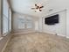 Bright living room with tile floors, a large TV, and lots of natural light at 345 Alcove Dr, Groveland, FL 34736