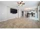 Open-concept living space features tile floors and connects to dining and kitchen areas at 345 Alcove Dr, Groveland, FL 34736