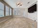 Bright living room featuring tile flooring, multiple windows, and a ceiling fan at 345 Alcove Dr, Groveland, FL 34736