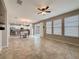 Open concept living room with tile flooring and natural light, seamlessly connected to the kitchen at 345 Alcove Dr, Groveland, FL 34736