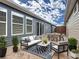 A lovely outdoor seating and dining area with patio furniture, plantings, and pavers at 345 Alcove Dr, Groveland, FL 34736