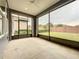 Screened in back porch, with view of backyard and brown wood fence at 345 Alcove Dr, Groveland, FL 34736