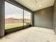 Screened in back porch, with view of backyard and brown wood fence at 345 Alcove Dr, Groveland, FL 34736