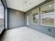Screened in back porch, with gray siding and view of backyard at 345 Alcove Dr, Groveland, FL 34736
