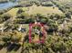 Aerial view showing the home inside a pink property line, surrounded by trees and neighboring houses at 36845 Taylor Mill Rd, Fruitland Park, FL 34731