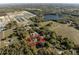 Aerial view showing the home inside a pink property line, in proximity to a lake and neighborhood at 36845 Taylor Mill Rd, Fruitland Park, FL 34731