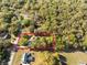 Aerial view showing the home inside a pink property line, surrounded by trees, with other houses nearby at 36845 Taylor Mill Rd, Fruitland Park, FL 34731