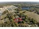Aerial view showing the home inside a pink property line, in proximity to a lake and neighborhood at 36845 Taylor Mill Rd, Fruitland Park, FL 34731