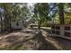 Backyard with trees, sheds and a chicken coop, and a view of the house at 36845 Taylor Mill Rd, Fruitland Park, FL 34731