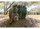 Backyard features utilities access with lush trees and a screened-in patio at 36845 Taylor Mill Rd, Fruitland Park, FL 34731