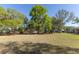 Spacious backyard featuring a well-maintained lawn and mature trees, creating a private and serene environment at 36845 Taylor Mill Rd, Fruitland Park, FL 34731
