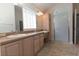 Bathroom featuring double sinks, lots of cabinet space, and a walk in shower at 36845 Taylor Mill Rd, Fruitland Park, FL 34731