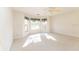 Bright bedroom with three windows allowing natural light and neutral colored carpet at 36845 Taylor Mill Rd, Fruitland Park, FL 34731