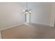 Light-filled dining room features neutral carpet and chandelier lighting at 36845 Taylor Mill Rd, Fruitland Park, FL 34731