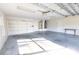 Spacious garage with built-in shelving, room for storage, and a side entry door at 36845 Taylor Mill Rd, Fruitland Park, FL 34731
