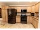 Bright kitchen with modern appliances and light wood cabinets at 36845 Taylor Mill Rd, Fruitland Park, FL 34731