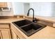 The kitchen features a double basin sink with black faucet, and stone counter tops at 36845 Taylor Mill Rd, Fruitland Park, FL 34731