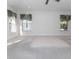 A spacious main bedroom with neutral carpeting and three windows at 36845 Taylor Mill Rd, Fruitland Park, FL 34731