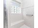 Tiled shower with a built-in bench and grab bar, lit by a glass block window at 36845 Taylor Mill Rd, Fruitland Park, FL 34731