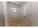 A storage room with a small window, built in shelving, and durable tile flooring at 36845 Taylor Mill Rd, Fruitland Park, FL 34731
