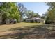 Spacious backyard with mature trees and view of home with screened porch at 36845 Taylor Mill Rd, Fruitland Park, FL 34731