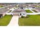 An elevated shot showcasing a cozy home surrounded by lush greenery in a vibrant neighborhood at 37031 Lake Overlook Dr, Grand Island, FL 32735