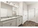 Bathroom with double granite vanity and large mirror at 37031 Lake Overlook Dr, Grand Island, FL 32735