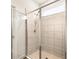 Bathroom featuring glass shower doors and tile surround at 37031 Lake Overlook Dr, Grand Island, FL 32735
