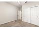Bedroom showcasing neutral carpet, closet space, ceiling fan, and access to another room at 37031 Lake Overlook Dr, Grand Island, FL 32735