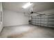 Spacious garage with white walls, concrete floor and open garage door at 37031 Lake Overlook Dr, Grand Island, FL 32735