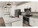 Modern kitchen featuring stainless steel appliances, granite countertops, and ample storage space at 37031 Lake Overlook Dr, Grand Island, FL 32735