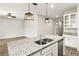 Kitchen island boasts a double sink, granite countertop, and pendant lighting at 37031 Lake Overlook Dr, Grand Island, FL 32735