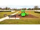 Community playground featuring a green slide and benches, perfect for outdoor fun and relaxation at 37031 Lake Overlook Dr, Grand Island, FL 32735