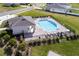 Aerial view of the community pool area, surrounded by lush landscaping at 37031 Lake Overlook Dr, Grand Island, FL 32735