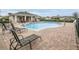 Community pool with sun loungers and restroom cabana at 37031 Lake Overlook Dr, Grand Island, FL 32735