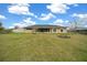 Spacious backyard with firepit and a view of the home's exterior at 3900 Sw 102Nd Pl, Ocala, FL 34476