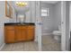 Bathroom features vanity with wood cabinets and black countertop at 3900 Sw 102Nd Pl, Ocala, FL 34476