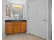 Bright bathroom features vanity with wood cabinets and black countertop at 3900 Sw 102Nd Pl, Ocala, FL 34476
