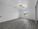 Bright bedroom with grey wood-look flooring, a ceiling fan, and a large window at 3900 Sw 102Nd Pl, Ocala, FL 34476