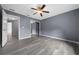 This bedroom features hardwood floors, a ceiling fan, and a mirrored closet at 3900 Sw 102Nd Pl, Ocala, FL 34476