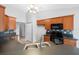 Kitchen boasts wood cabinets, black appliances, tile backsplash, and a stainless steel, double-basin sink at 3900 Sw 102Nd Pl, Ocala, FL 34476