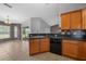 Beautiful kitchen features wood cabinetry, tiled flooring, a breakfast bar, and access to the outdoors via sliding glass doors at 3900 Sw 102Nd Pl, Ocala, FL 34476