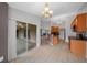 Spacious kitchen boasts tiled flooring, wood cabinets, black appliances, and access to the screened-in patio via sliding doors at 3900 Sw 102Nd Pl, Ocala, FL 34476