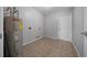 Laundry room features tile flooring, water heater, and door to living space at 3900 Sw 102Nd Pl, Ocala, FL 34476