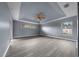 A large main bedroom features a ceiling fan, tray ceiling, and natural light from two windows at 3900 Sw 102Nd Pl, Ocala, FL 34476