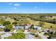 Aerial view of a home surrounded by beautiful landscaping and green spaces, located within a golf community at 3909 River Crest Cir, Leesburg, FL 34748