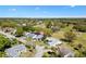 Elevated aerial view of home nestled within a serene neighborhood with lush landscaping and a golf course at 3909 River Crest Cir, Leesburg, FL 34748