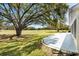 Serene backyard view with a concrete patio overlooking the golf course and lush green space at 3909 River Crest Cir, Leesburg, FL 34748